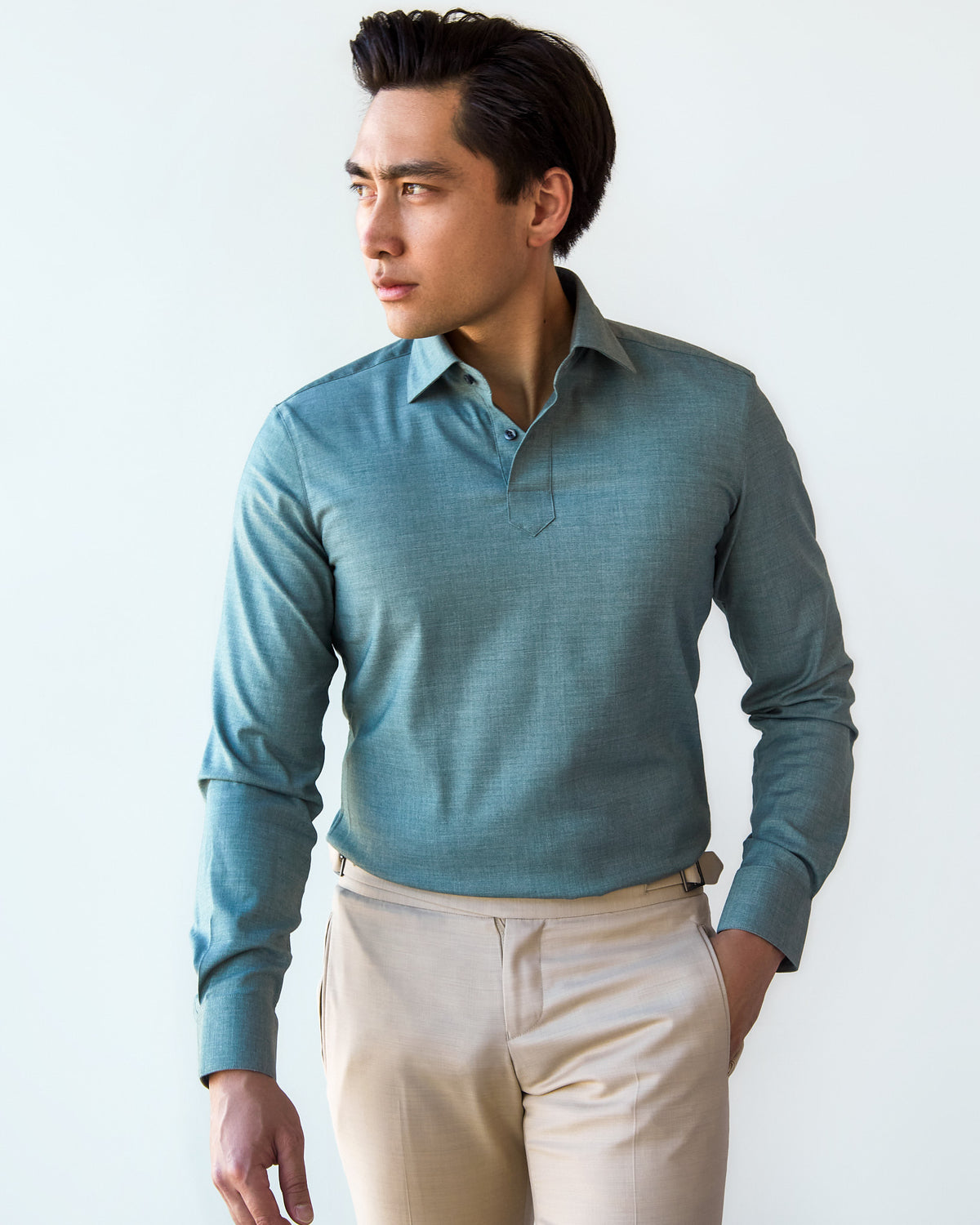 Green Popover Shirt, closer front crop with hands clasped at the waist