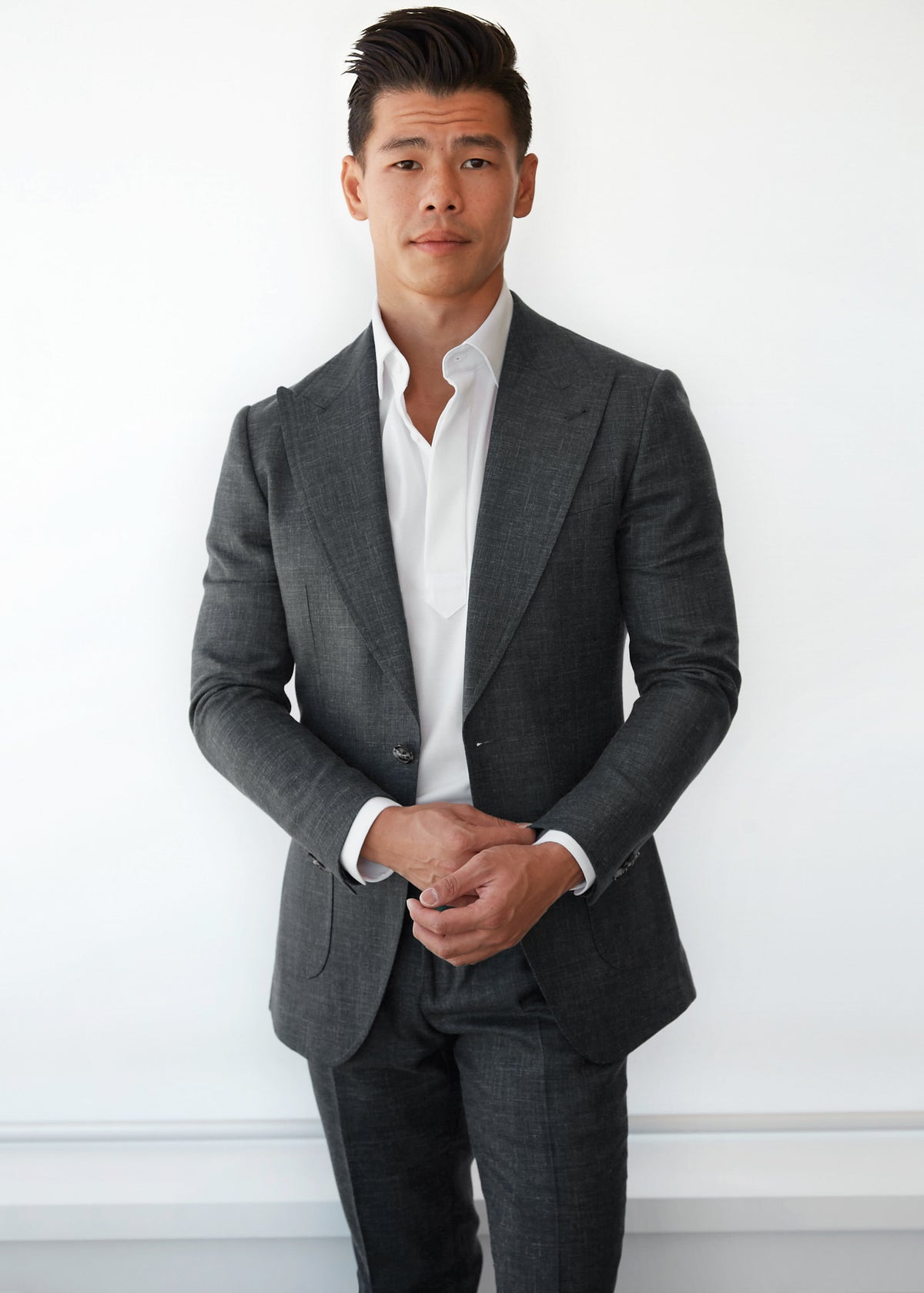 Martin Place Charcoal Linen Blend Suit, front-on view with hands clasped
