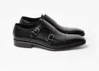 Pair of painted calf double monk shoes in black, angled view