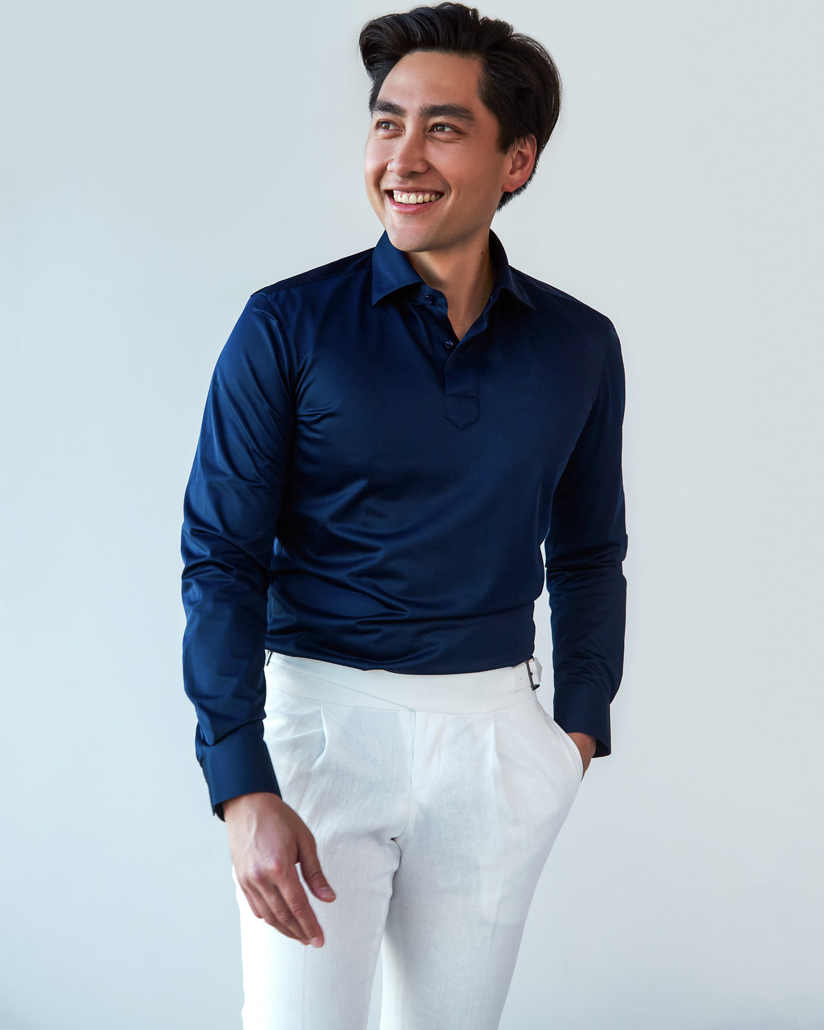Navy Popover Shirt with sleeves worn long, tighter crop, neutral expression