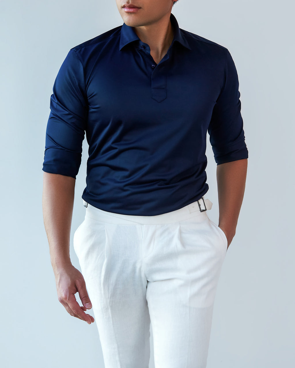 Navy Popover Shirt with sleeves worn long, a model smiling and looking aside