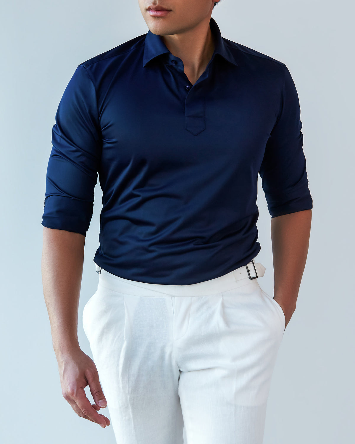 Navy Popover Shirt, close front crop with a hand in the pocket, gaze lowered slightly