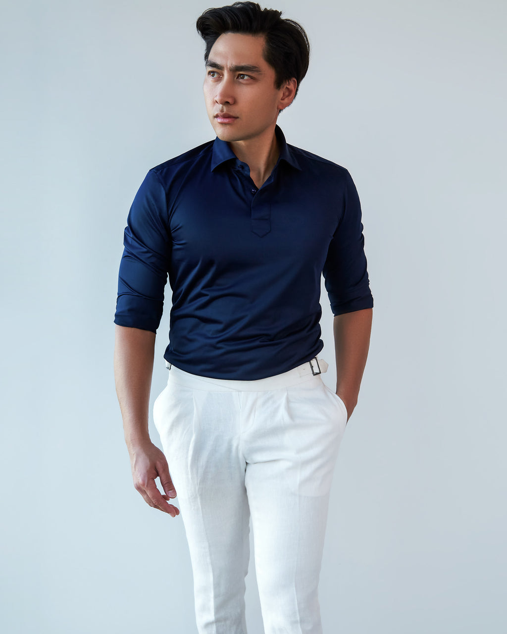 Navy Popover Shirt, three-quarter front view with a hand in the pocket, looking aside