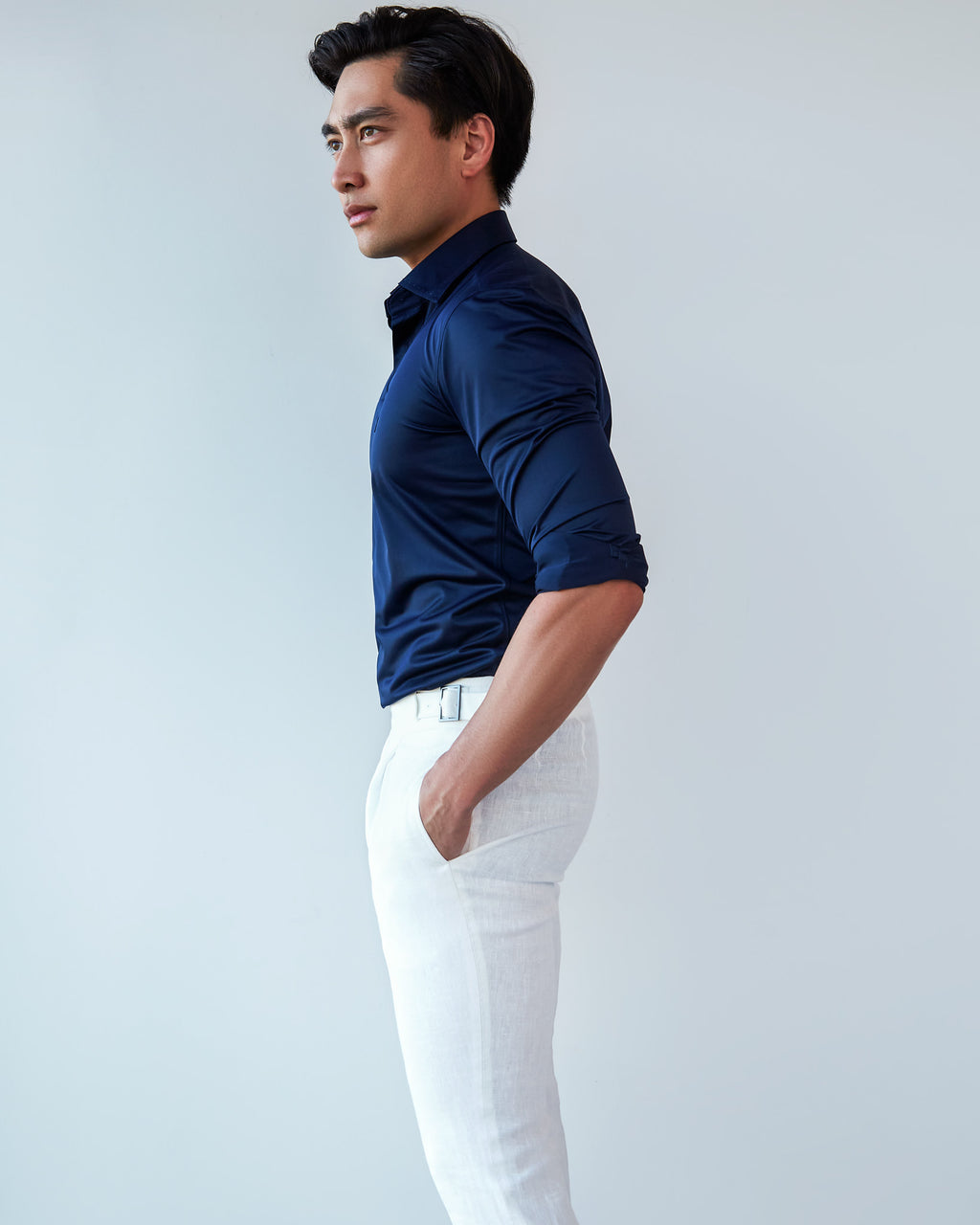 Navy Popover Shirt, side profile with sleeves rolled, a model looking away