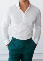 Ivory popover shirt worn on a model with green trousers, close-up torso view