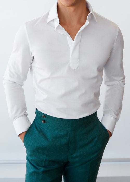 Ivory popover shirt worn on a model with green trousers, close-up torso view