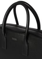 Close-up of the Timothy briefcase handles and embossed THDR logo