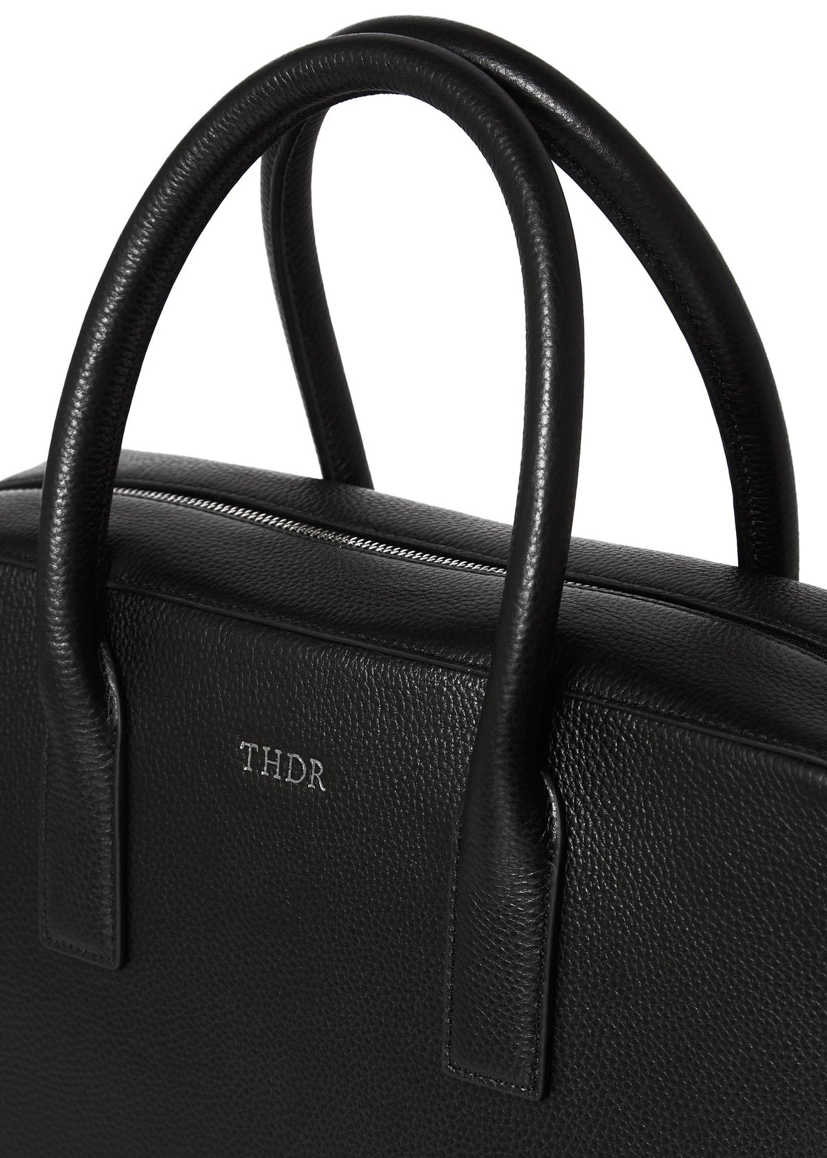 Close-up of the Timothy briefcase handles and embossed THDR logo