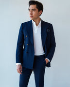 White Popover Shirt layered under an open navy double-breasted blazer with a pocket square