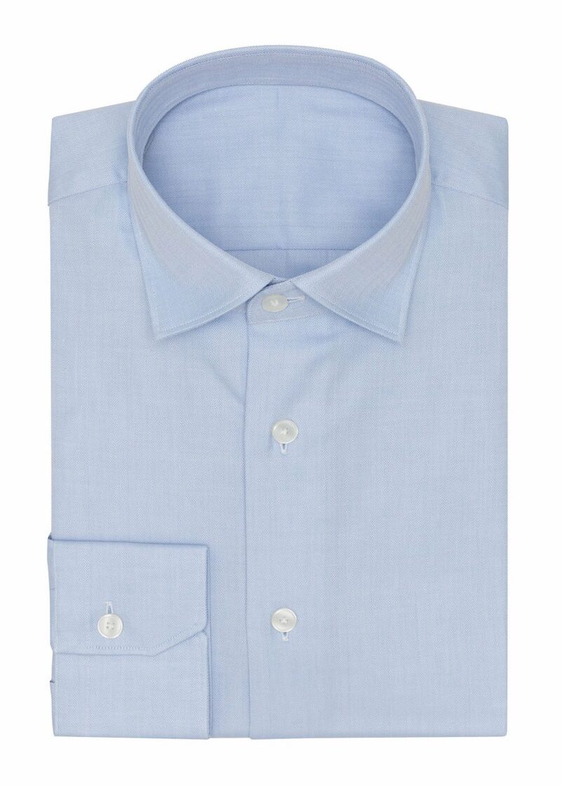 Fine herringbone shirt in light blue, folded flat on a plain background