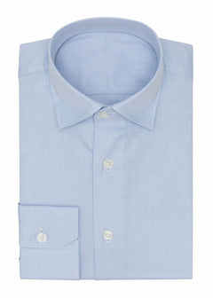 Fine herringbone shirt in light blue, folded flat on a plain background