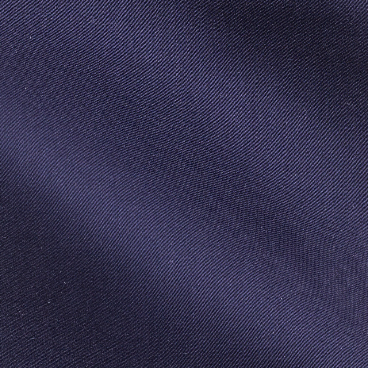 Close-up of the satin dark blue shirt fabric's fine woven texture