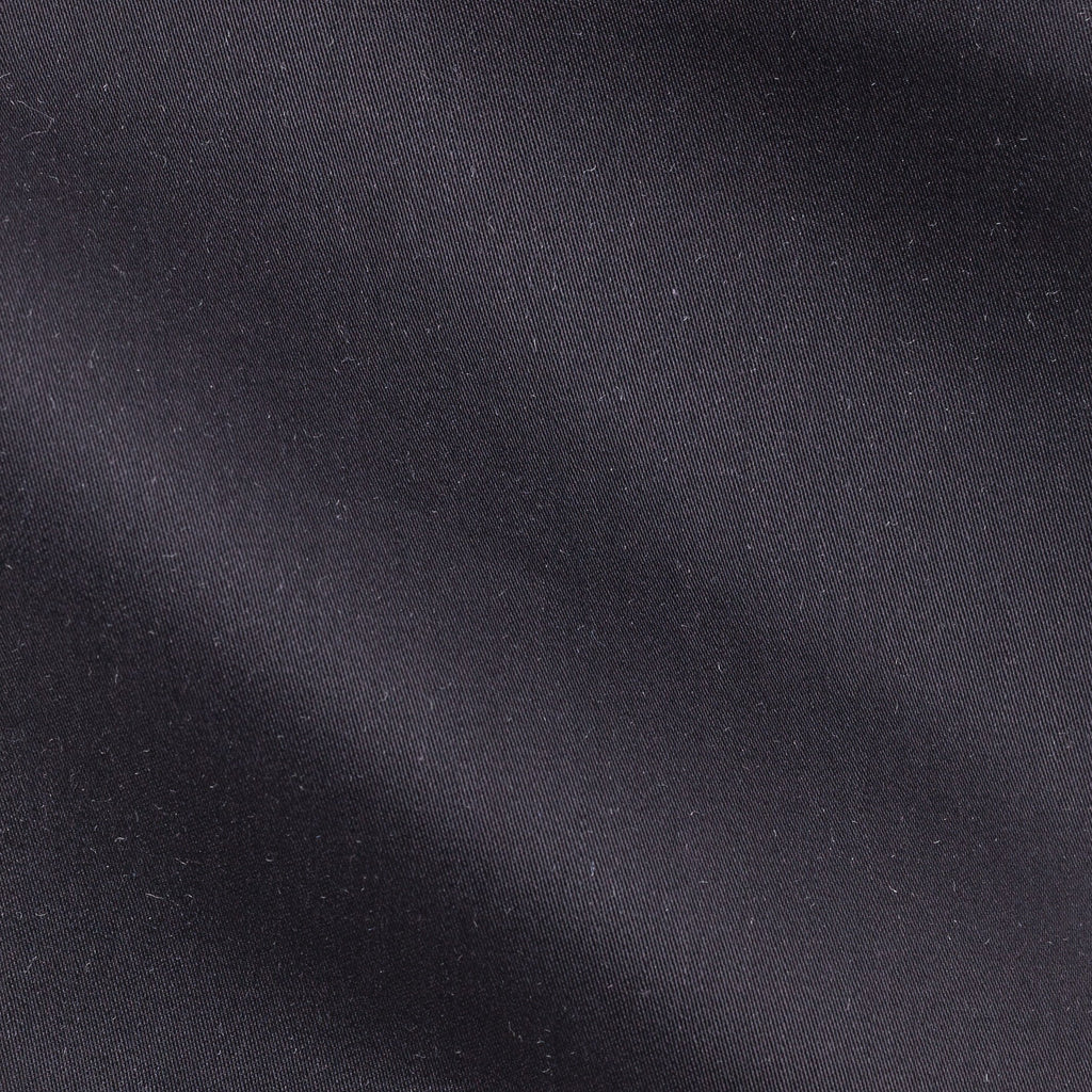 Close-up of the satin piquet black shirt's woven texture