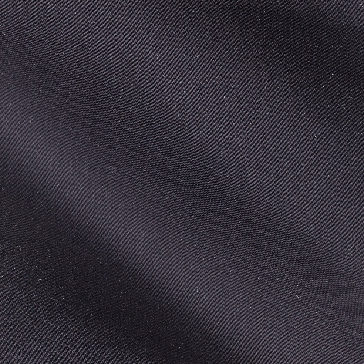 Close-up of the satin piquet black shirt's woven texture