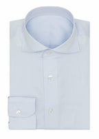 The Perfect Light Blue Shirt folded flat with collar and button placket