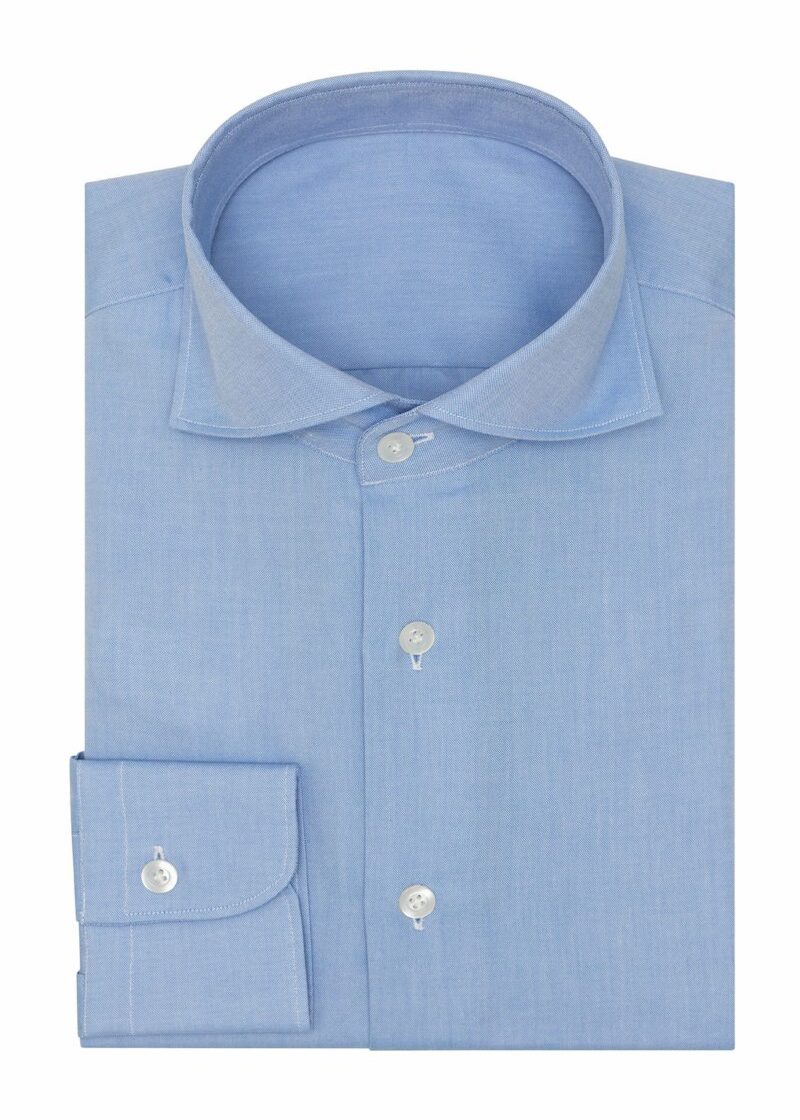 Oxford Mid Blue Shirt folded flat, showing the collar, button placket and cuff