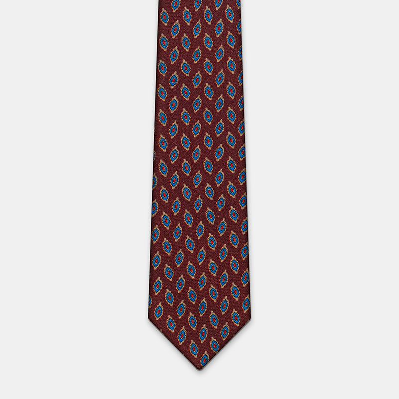 Taipei Tie in a burgundy paisley print, flat lay close-up of the blade tip