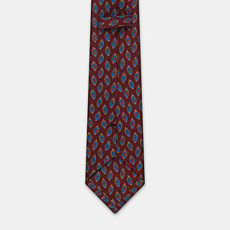 Taipei Tie in a burgundy paisley print, flat lay showing the fold near the neck