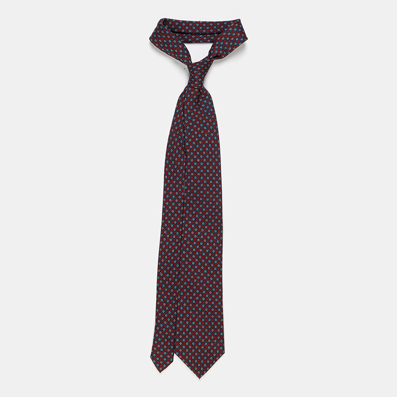 Boston Tie in a navy floral medallion print, knotted and hanging straight