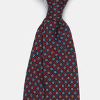 Boston Tie in a navy floral medallion print, angled close-up of the knot