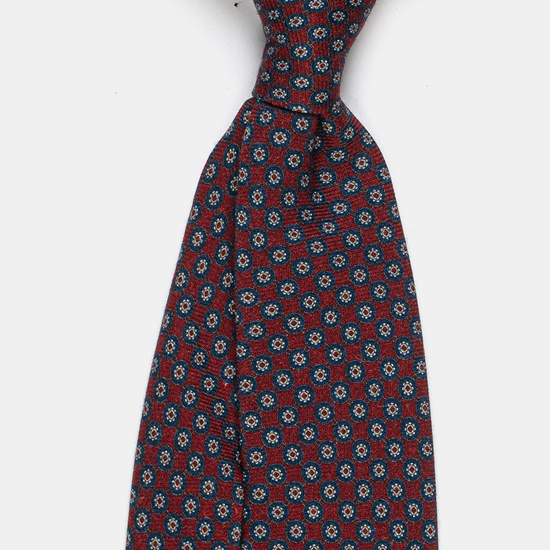 Boston Tie in a navy floral medallion print, angled close-up of the knot
