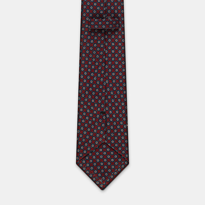 Boston Tie in a navy floral medallion print, keeper loop and tip visible