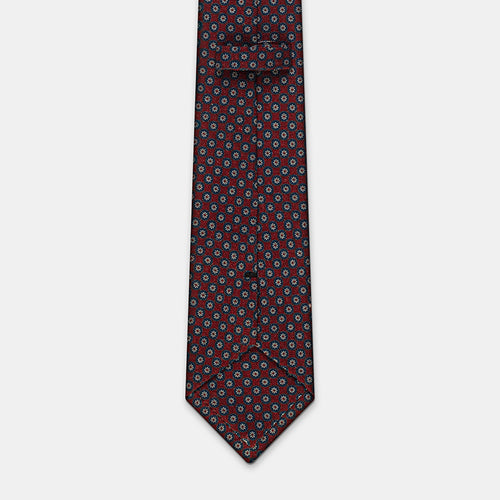 Boston Tie in a navy floral medallion print, keeper loop and tip visible