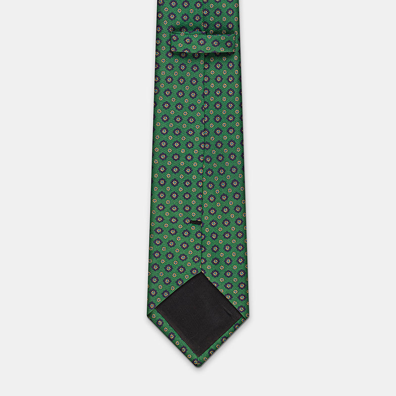 Seattle Tie in a green floral medallion print, angled view of knot and tip