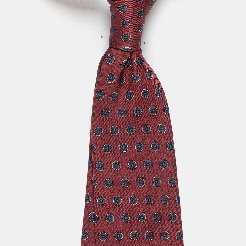 Riga Tie in a burgundy floral medallion print, angled close-up of the knot
