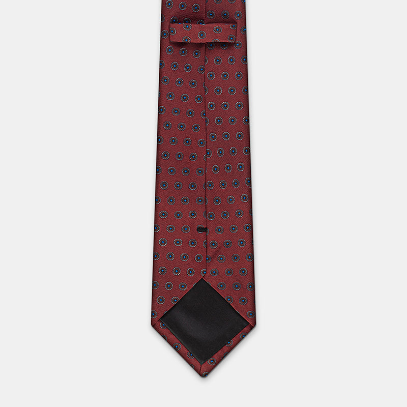 Riga Tie in a burgundy floral medallion print, keeper loop and tip visible