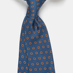Oslo Tie in a blue floral medallion print, angled close-up of the knot