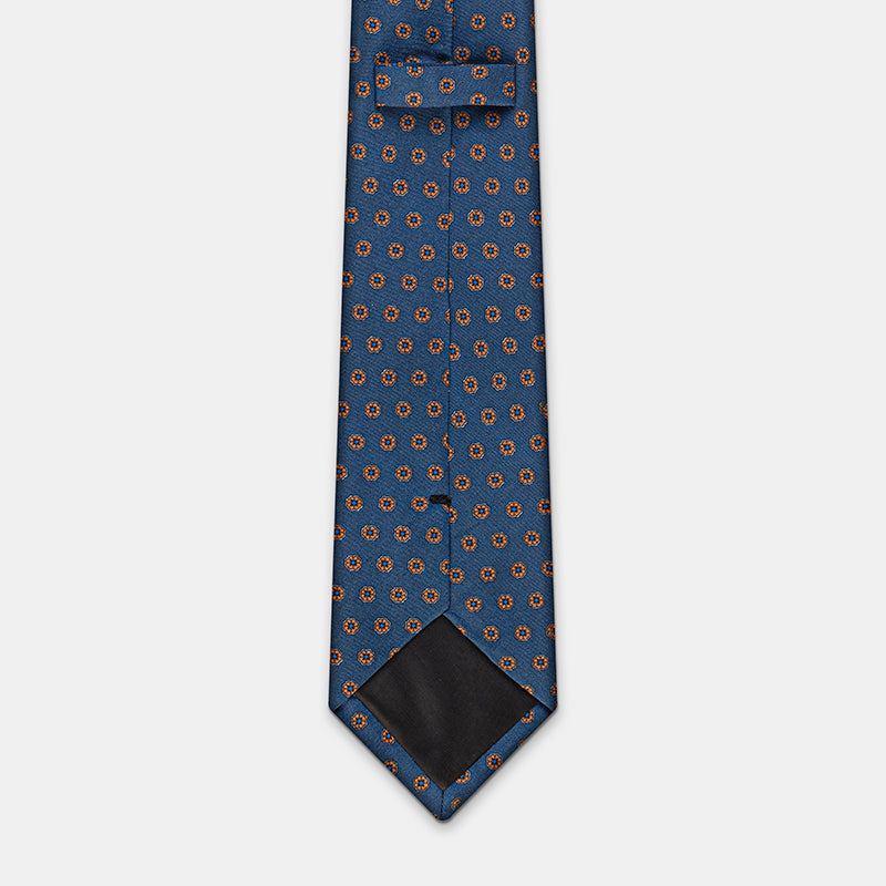 Oslo Tie in a blue floral medallion print, knotted with collar open