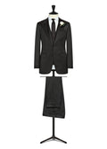 Dallington Black Twill Wool Tuxedo displayed on a stand with a white boutonniere