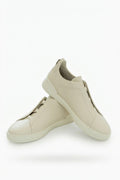 The Capri Cream Leather Slip-On Sneaker, pair in the studio