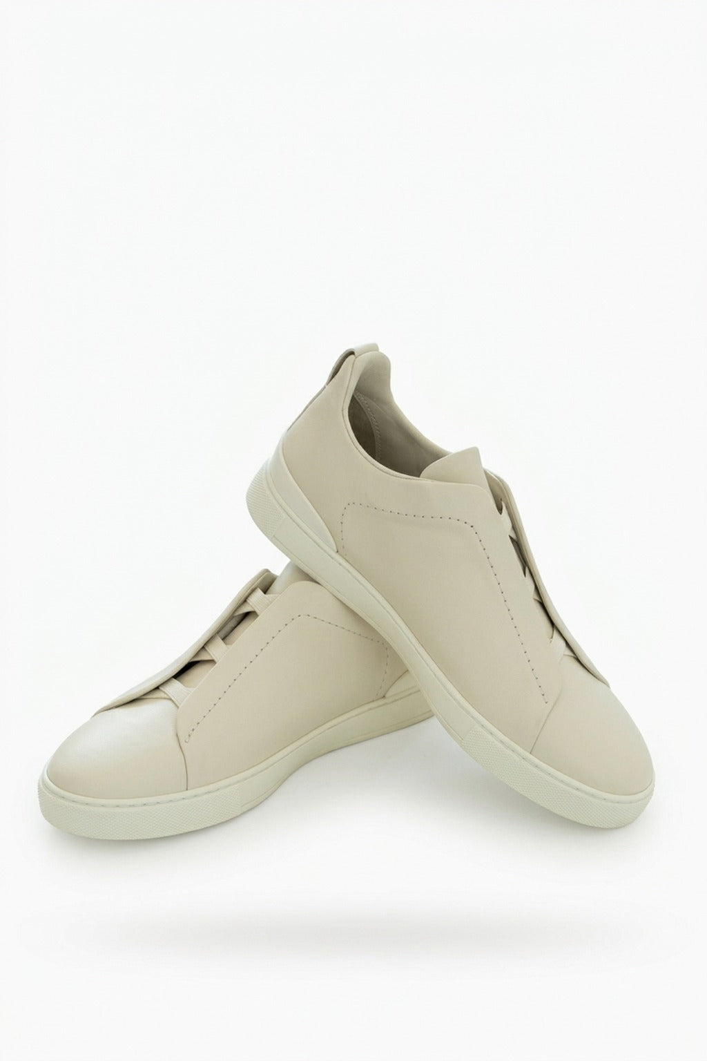 The Capri Cream Leather Slip-On Sneaker, pair in the studio