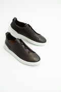 The Capri Dark Brown Leather Slip-On Sneaker, pair in the studio