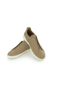 The Capri Taupe Nubuck Slip-On Sneaker, pair in the studio