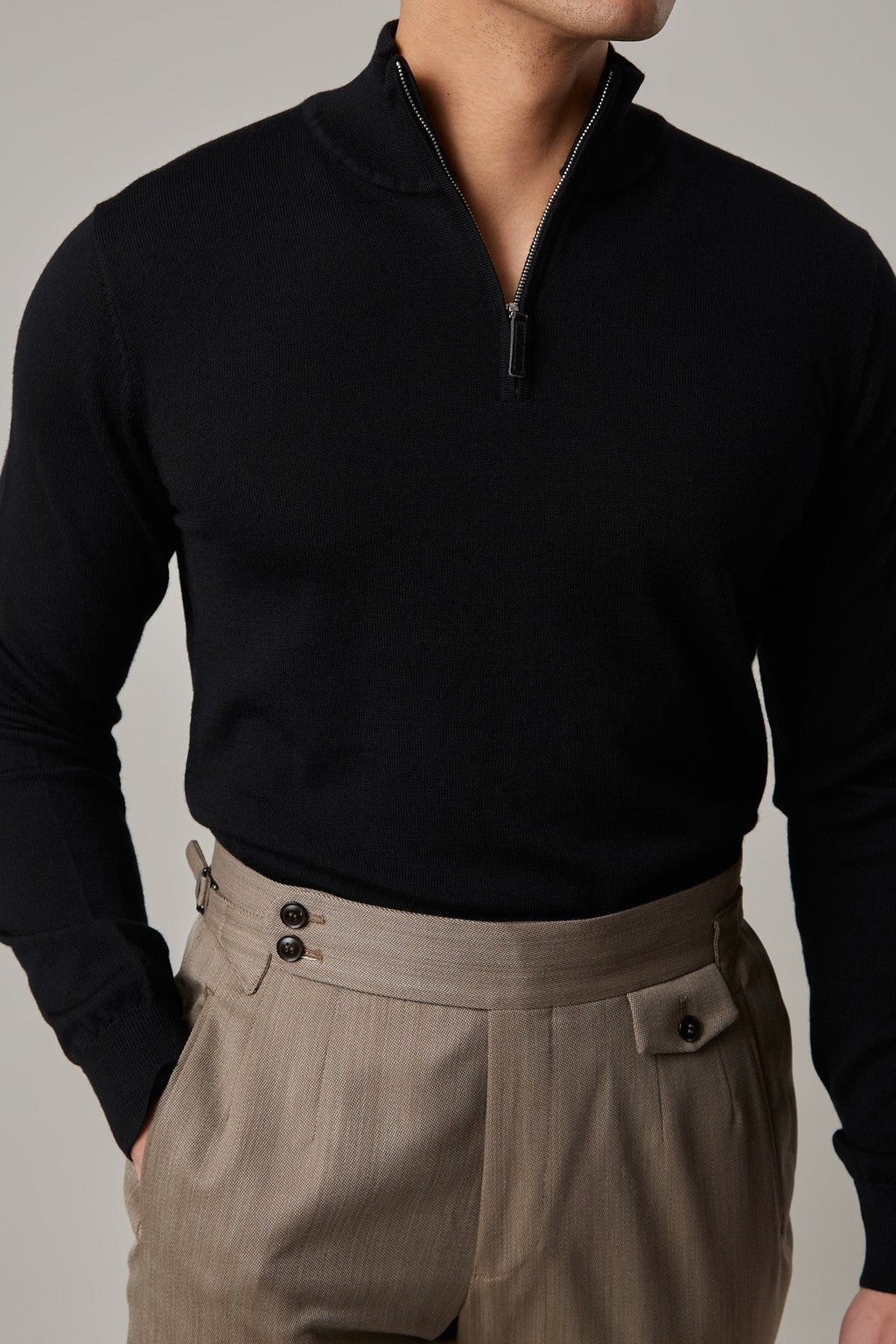 Cosmo quarter-zip jumper in black, worn on a model with the zip half-open