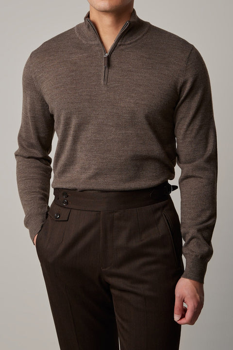 Cosmo quarter-zip jumper in brown, worn on a model with hand in pocket