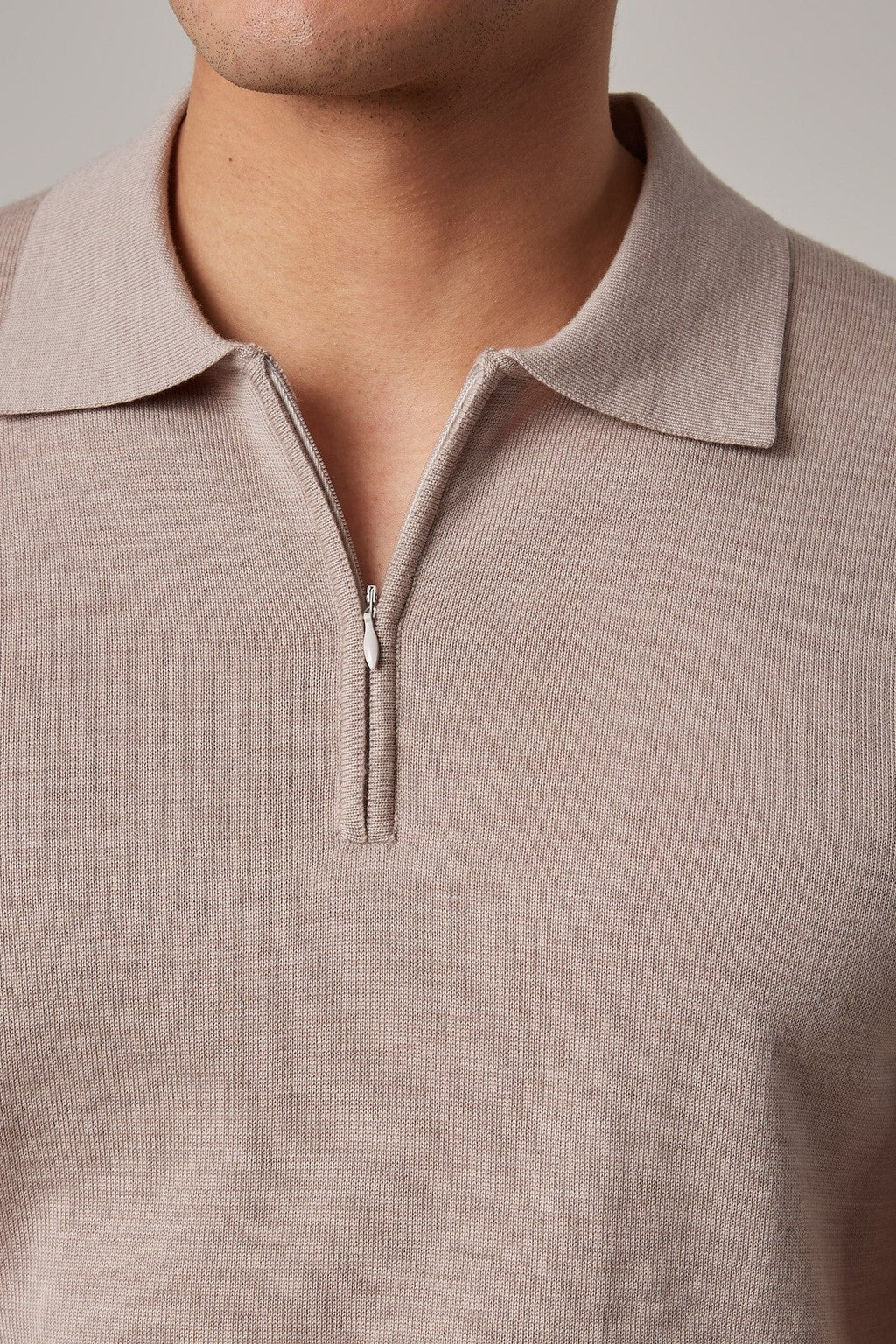 Close-up of the quarter-zip collar on the Fireball Zip Polo Beige