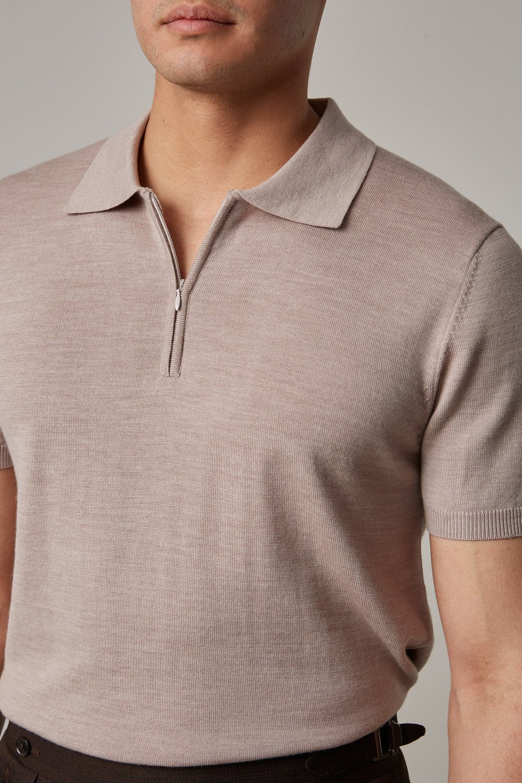Fireball Zip Polo Beige collar close-up with the trouser waistband in view