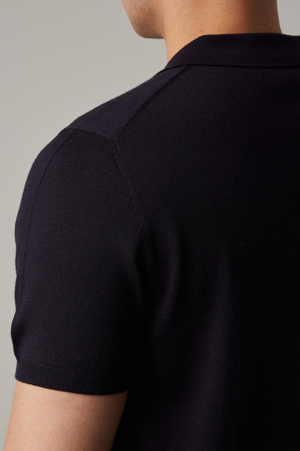 Back shoulder close-up of the Fireball Zip Polo Navy showing the knit texture