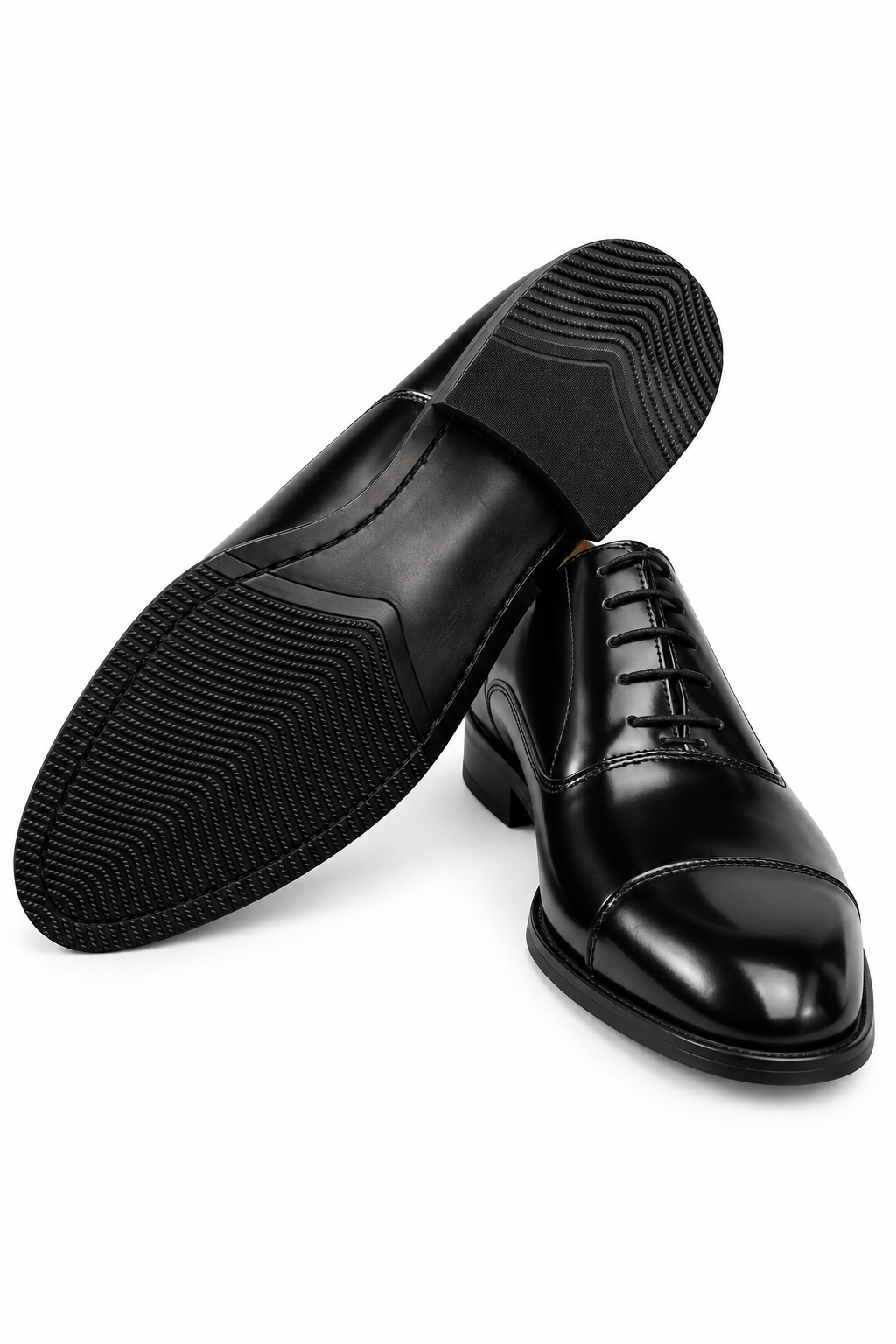 The Haider Black Patent Leather Oxford pair on white, one shoe turned to show the sole