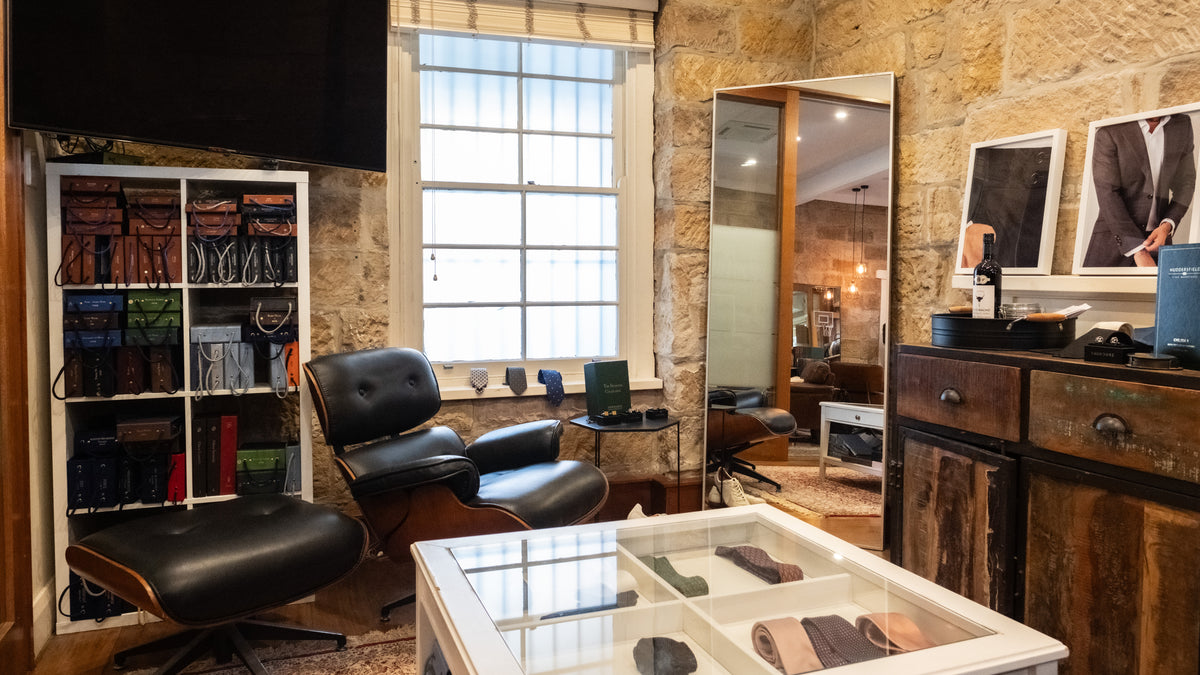 The studio: the cloth library, a display table of ties and the fitting mirror by the sash window