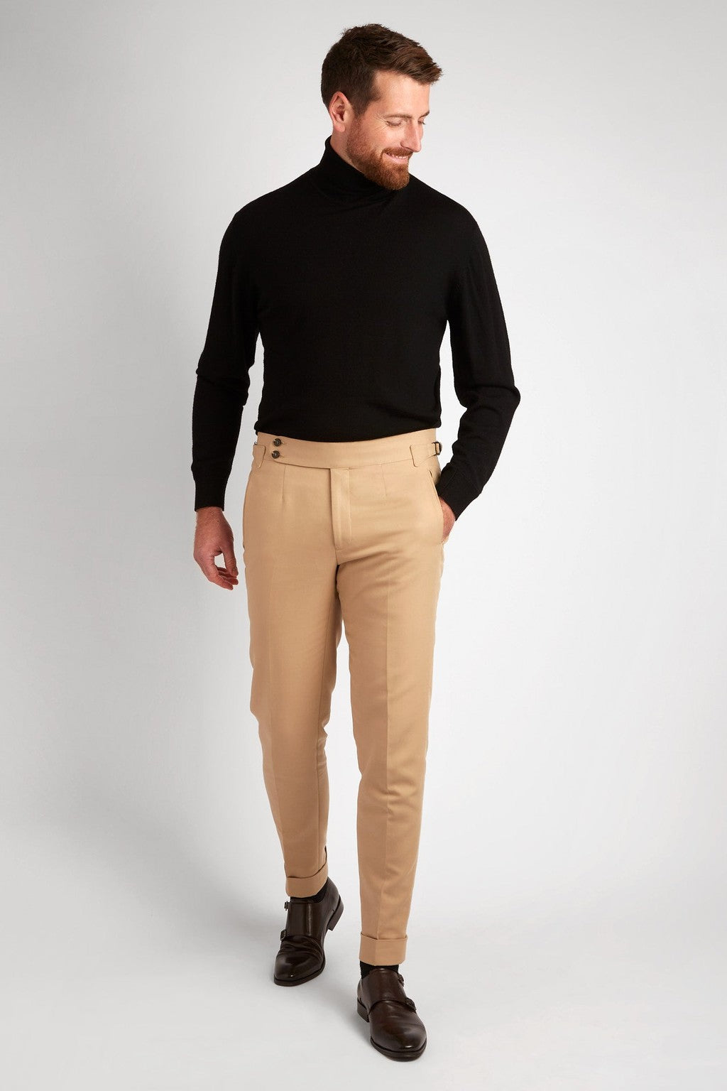 Irish Coffee Turtleneck Black worn with tan trousers, full-length, looking down