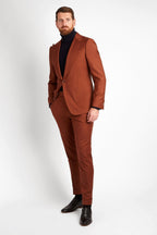 Irish Coffee Turtleneck Navy layered under a rust suit jacket, full-length side angle