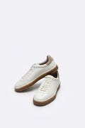 The Lido White Leather Sneaker, pair in the studio