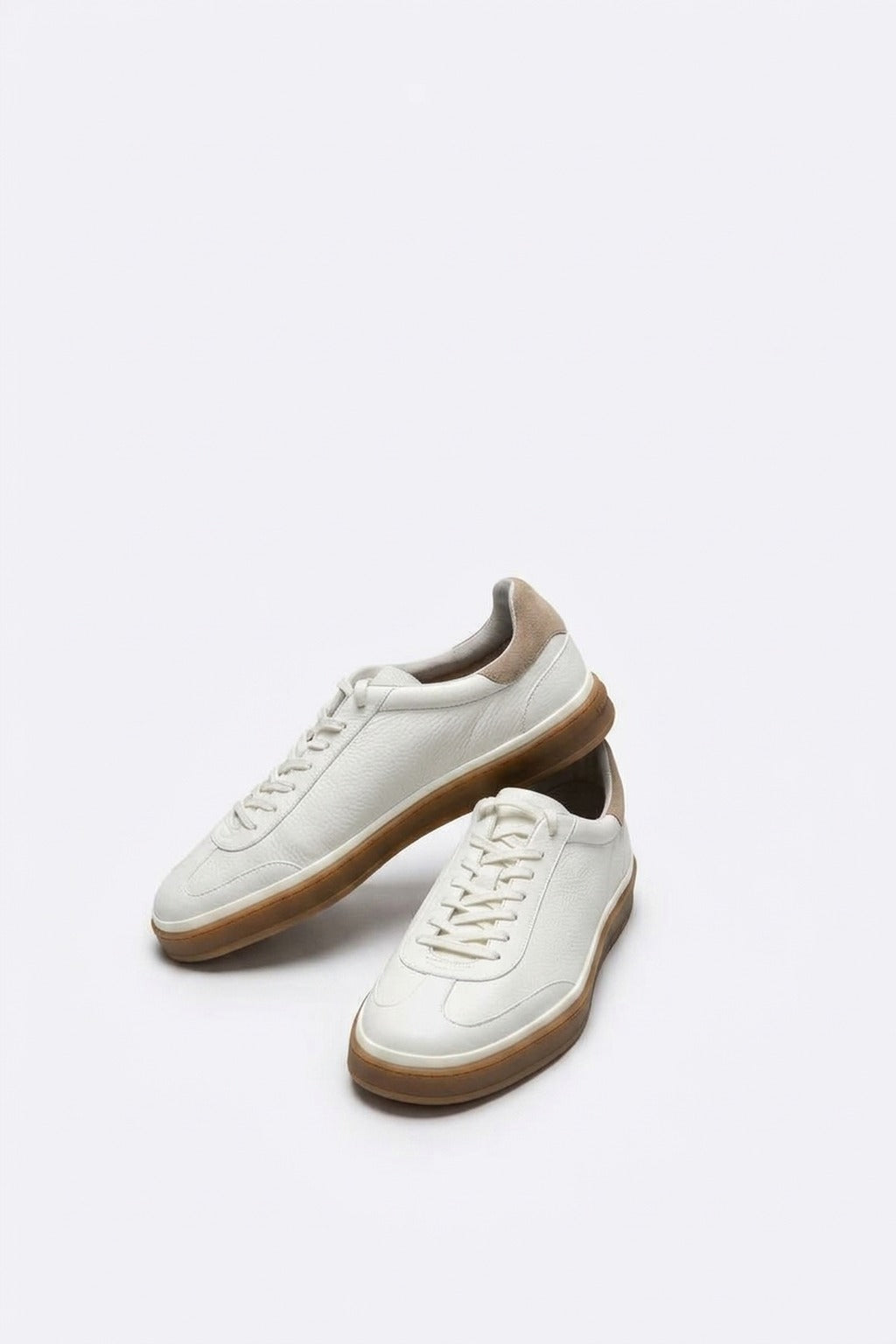 The Lido White Leather Sneaker, pair in the studio
