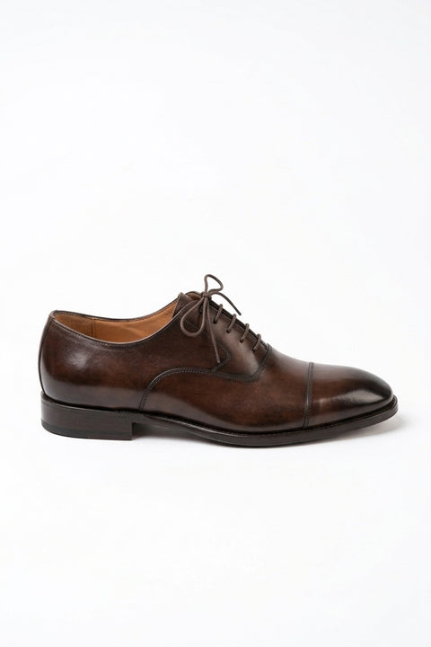 The Maison Soft Leather Brown Derby on white, side profile showing the burnished cap toe and sole