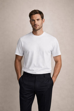 The Essential White Tee, front view on a model with navy trousers, hands in pockets